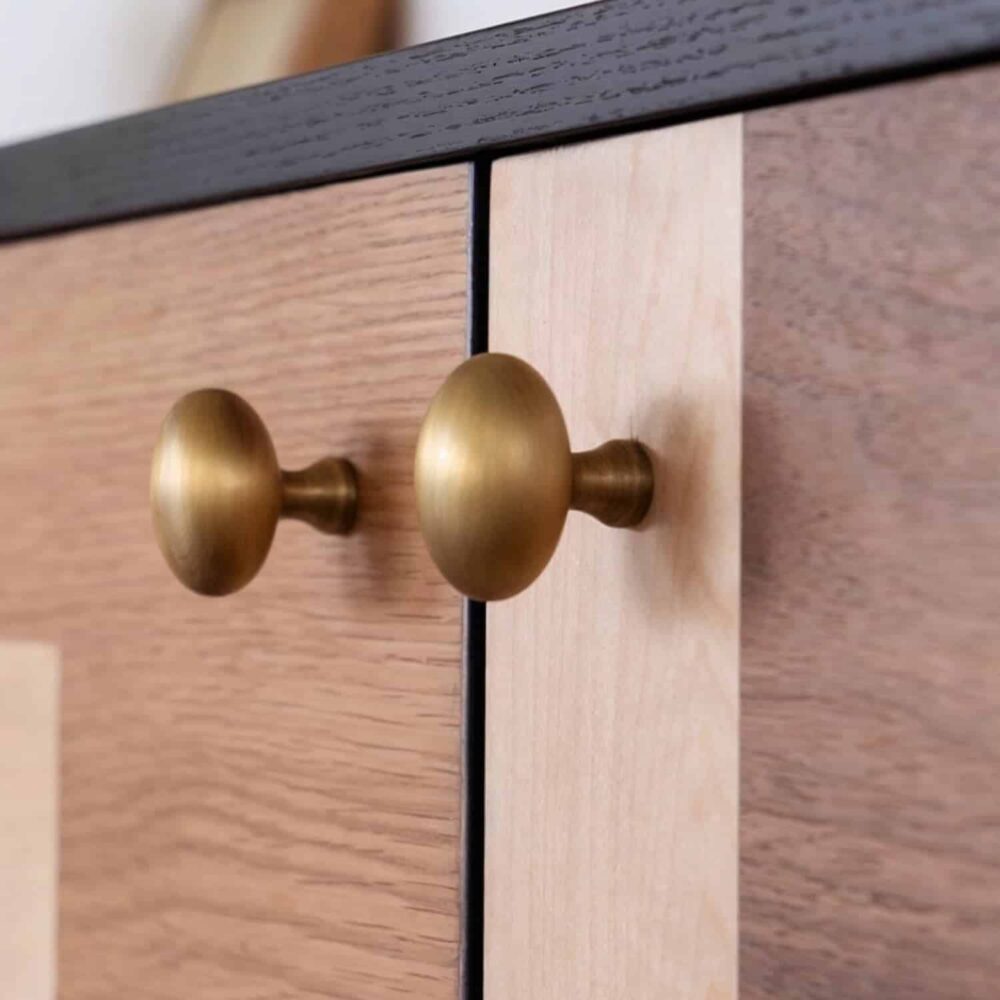 close_up_solid_brass_knobs_patchwork_sideboard_doors.jpg Close-up of